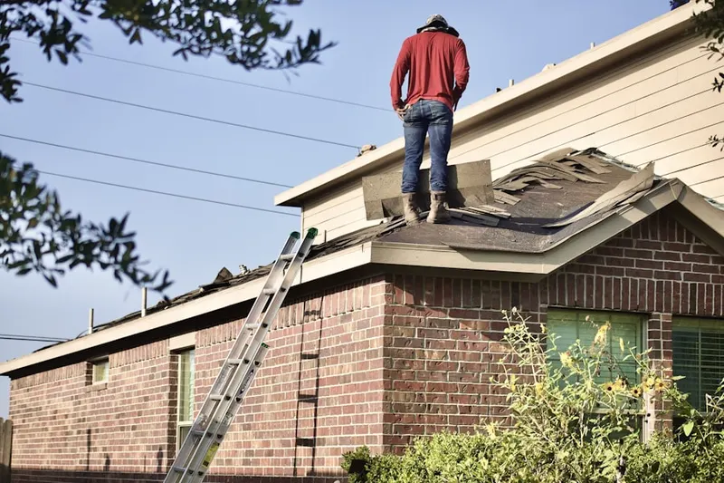 Professional roofer working on a residential roof in Islands of Beaufort